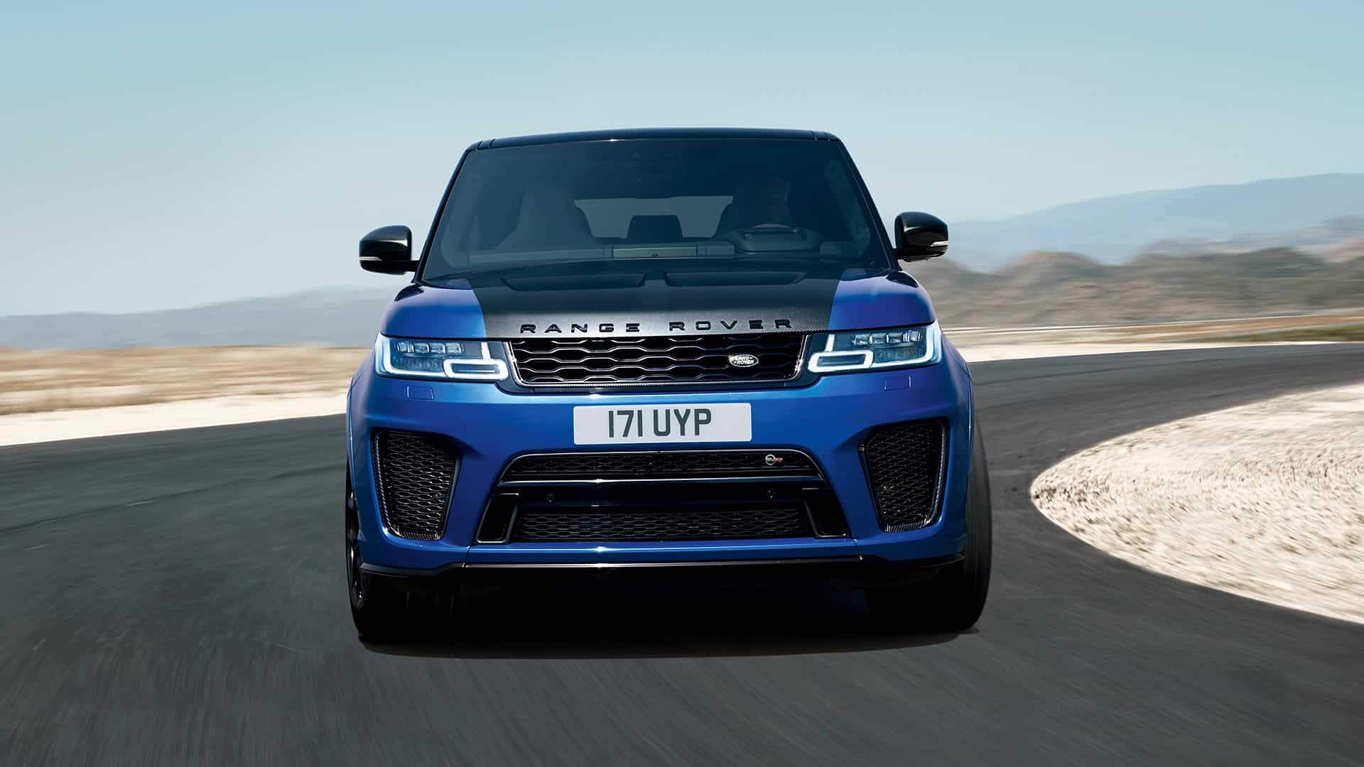 Blue Range Rover Sport driving round a corner