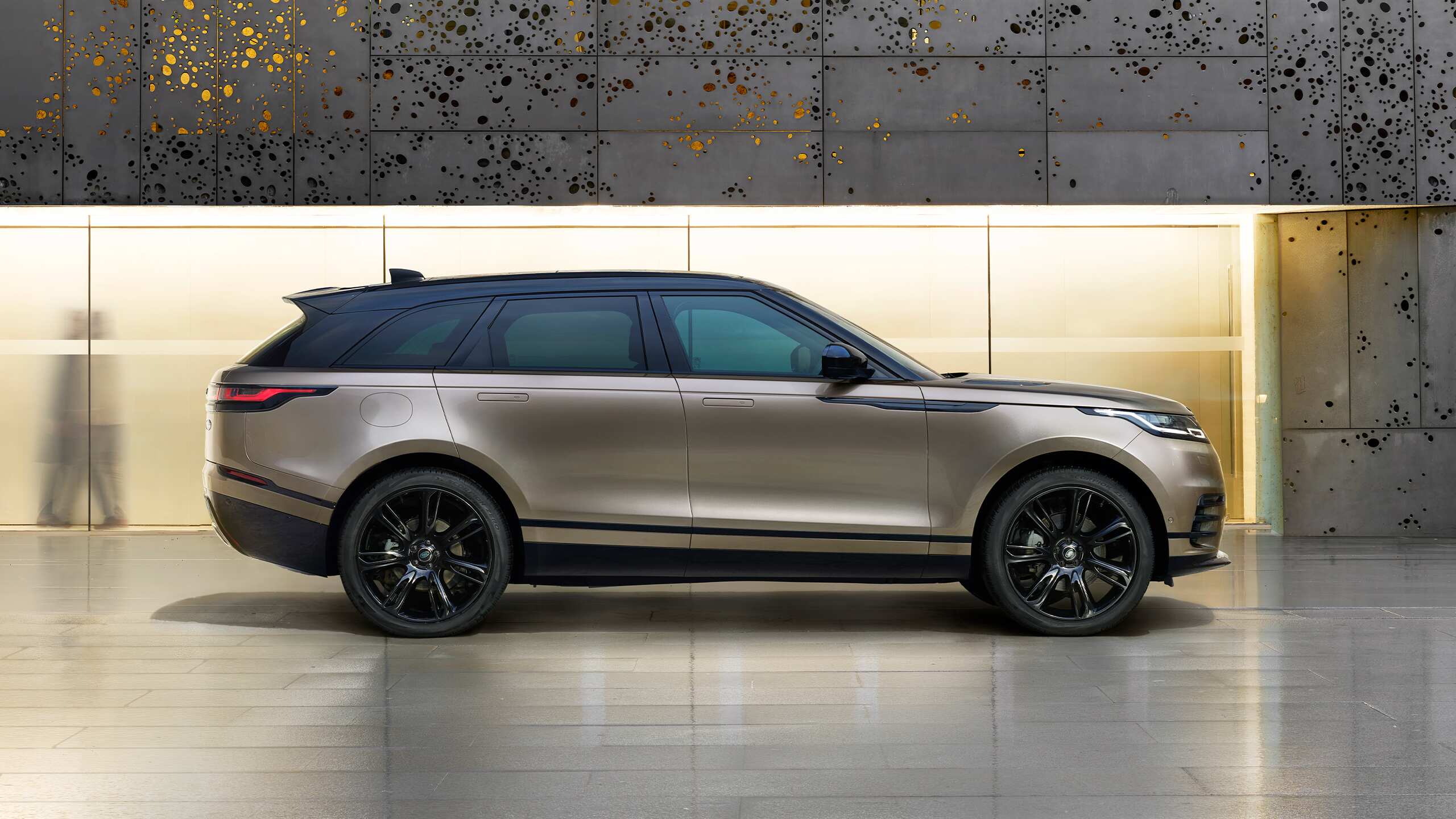 Velar parked in front of a Classic showroom