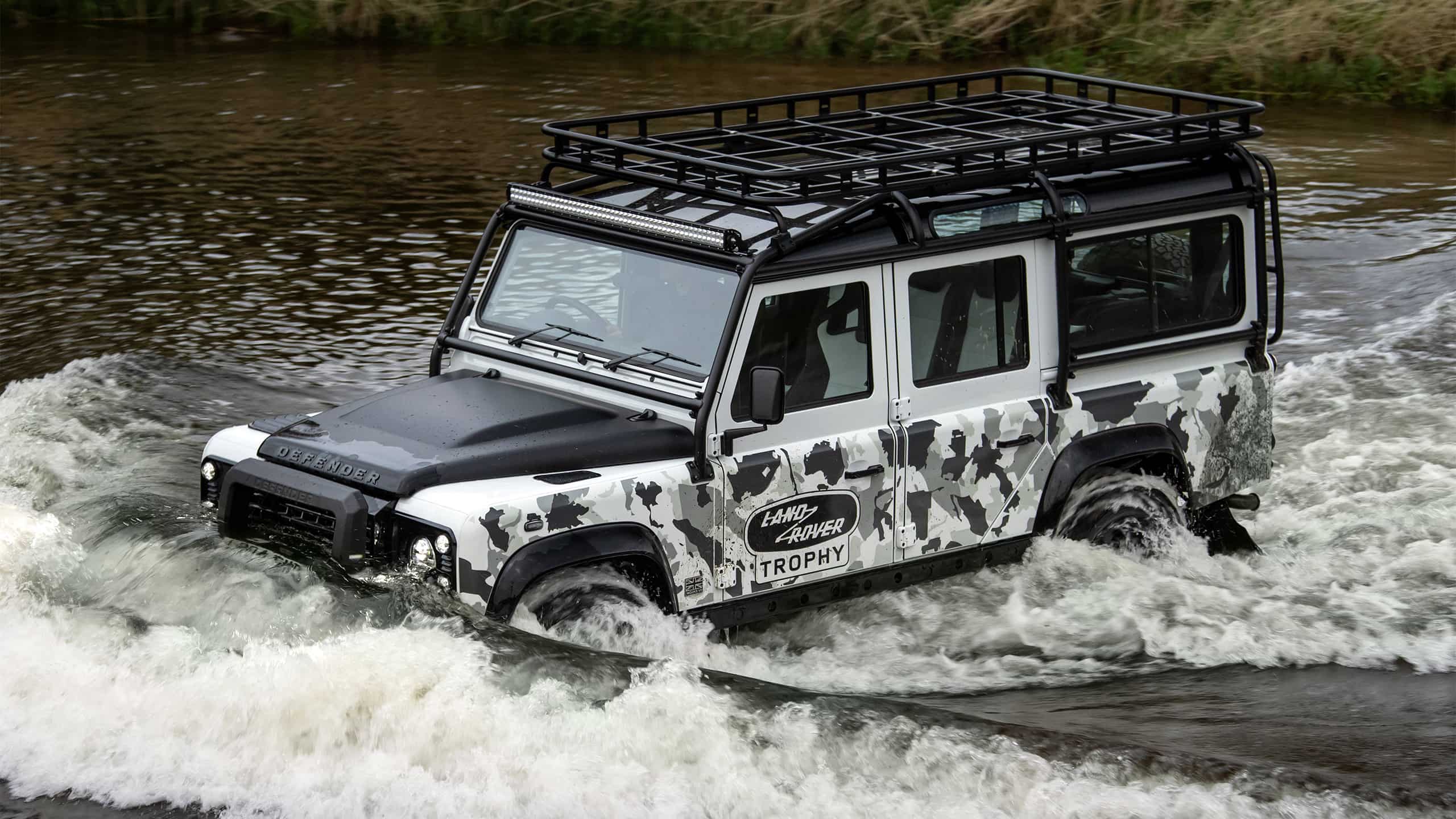 Defender classic car in the river 