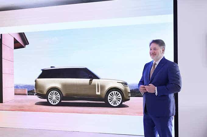 A man presenting in front of the New Range Rover