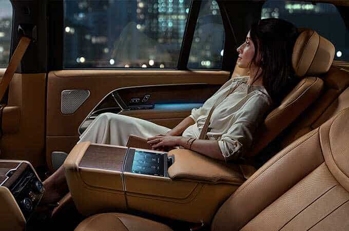 A woman reclining in the back of the New Range Rover
