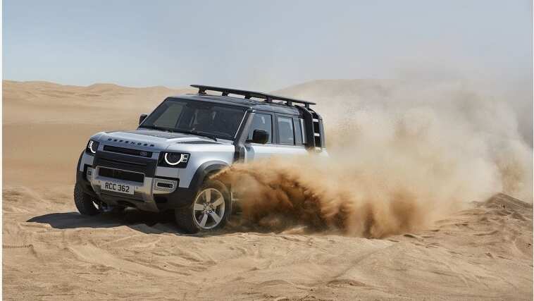 Land Rover Defender driving in desert