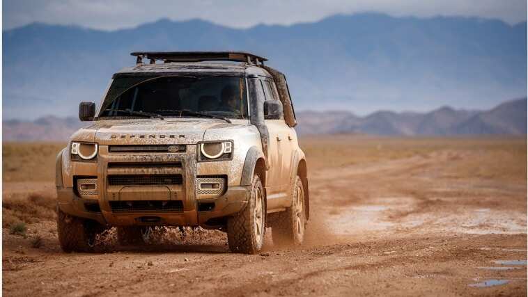 Land Rover Defender driving dirty in mud