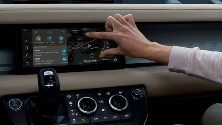 Person zooms in touch screen of a land rover vehicle