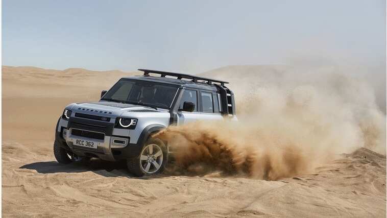 Land Rover Defender driving in sand