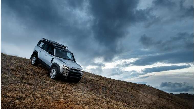 Land Rover Defender driving on a hill