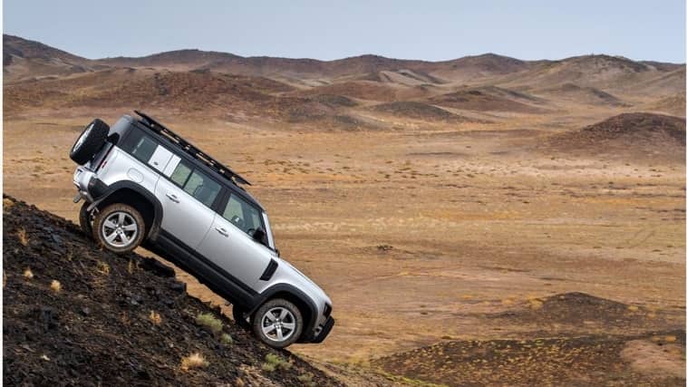 Land Rover Defender parked on a rock
