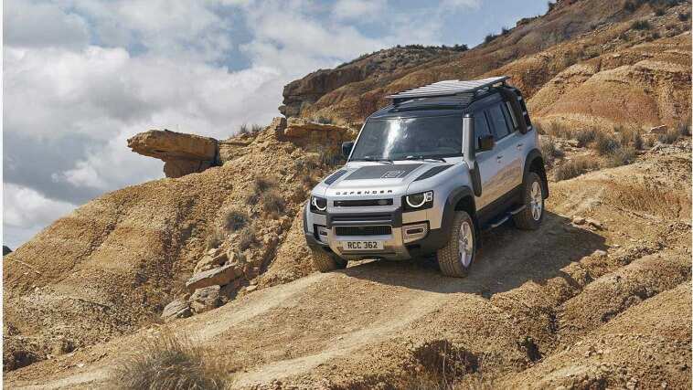 Land Rover Defender parked on a rock
