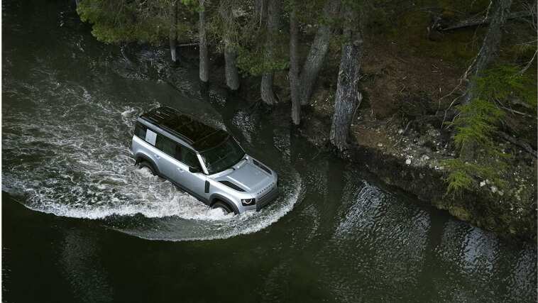 Land Rover Defender crossing a river