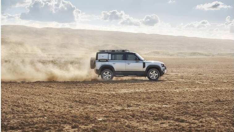 Land Rover Defender in desert side view