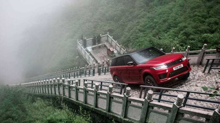 Range Rover in red driving on stairs