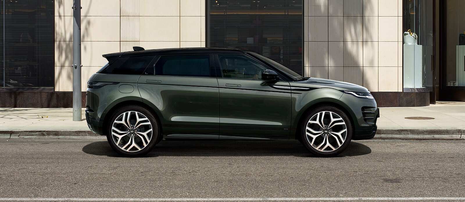 Range Rover Evoque in dark green parked side view