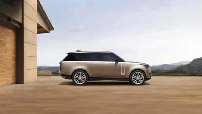 New Range Rover parked in front of a house side view