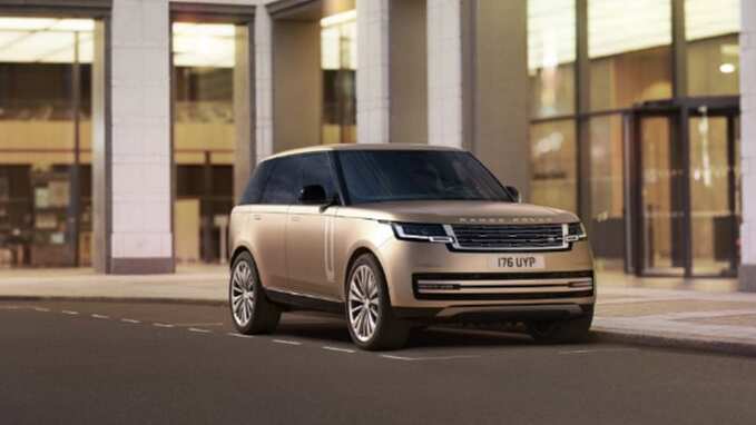New Range Rover in gold parked front side view