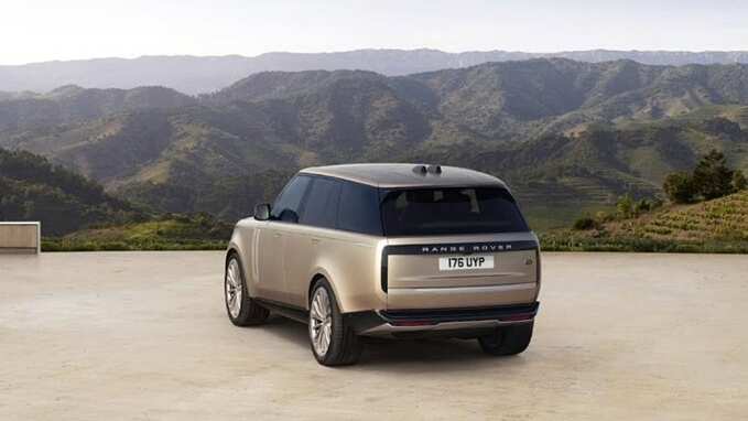 Range Rover in gold parked back side view