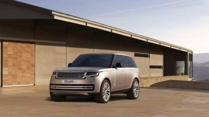 New Range Rover parked in front of a house