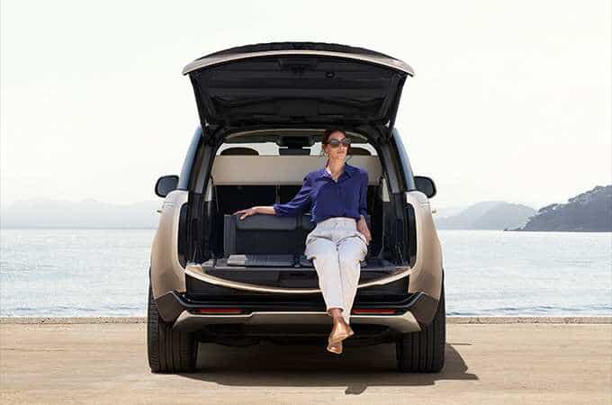 Woman sitting in the boot of the New Range Rover