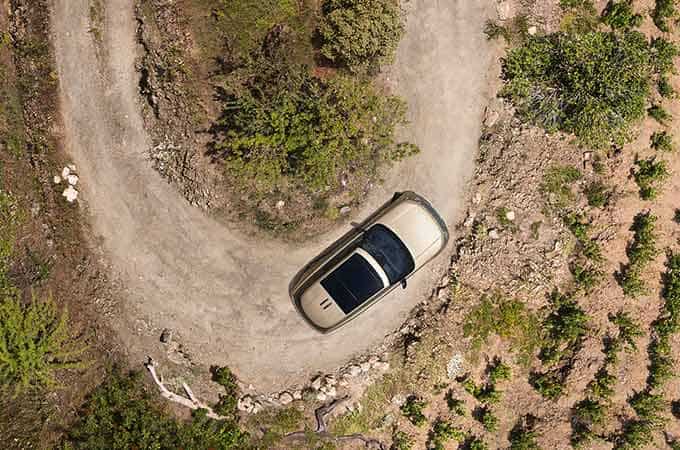 Bird's eye view of the New Range Rover on a dirt road