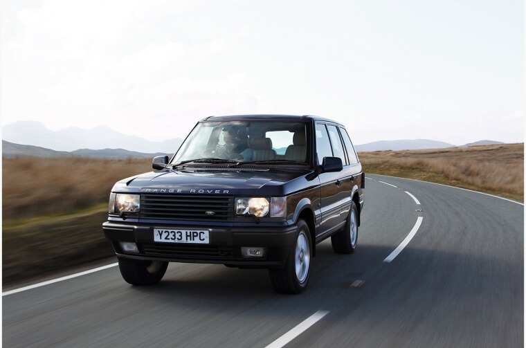 Range Rover driving on road. 