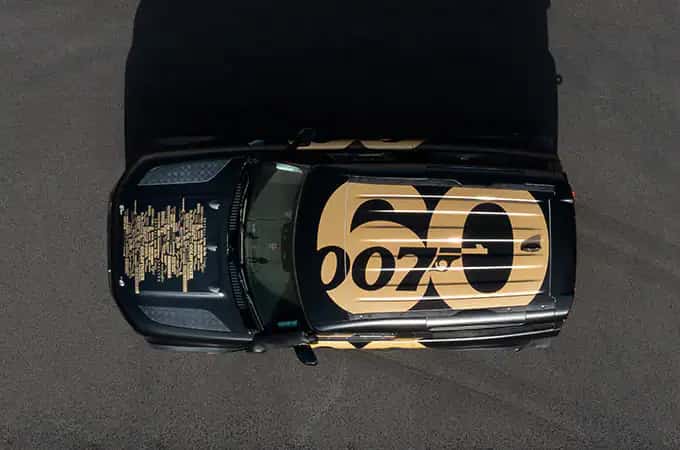 Land Rover Defender 90 In Special Livery In Black And Gold With The Names Of 25 007 Films