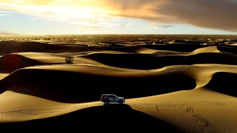 Land Rover Discovery driving through desert