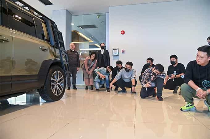 Customers photographing Land Rover vehicle