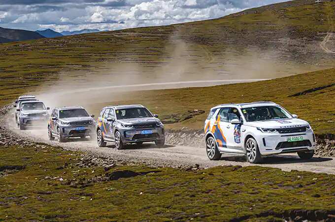 Land Rover convoy driving on dirt road