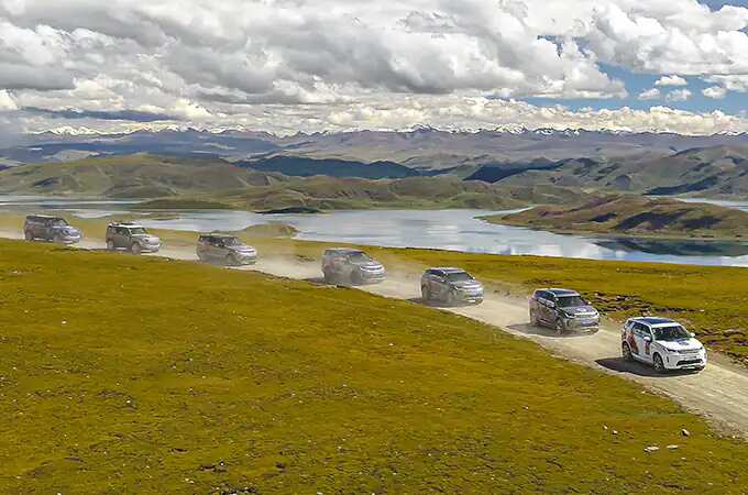 Land Rover convoy driving on dirt road