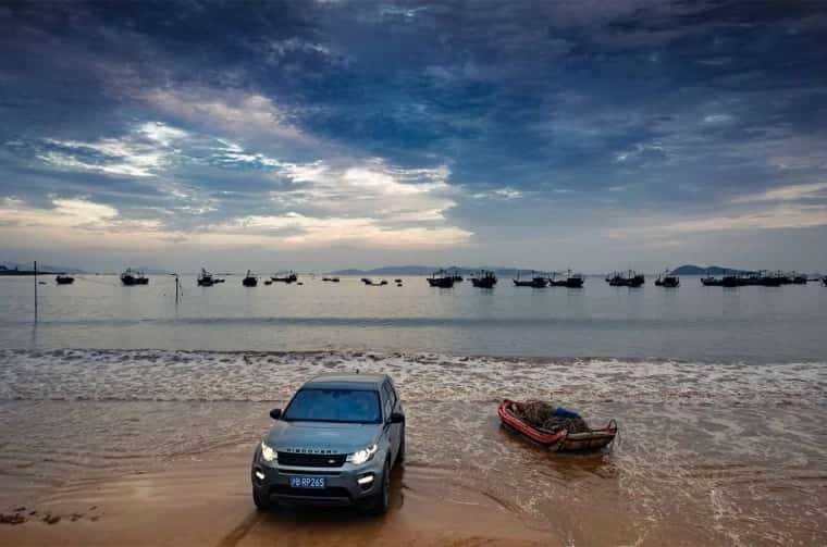 Land Rover Discovery parked on beach