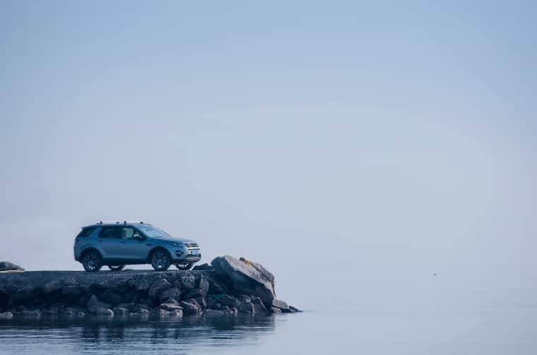 Land Rover Discovery parked on rocky coast