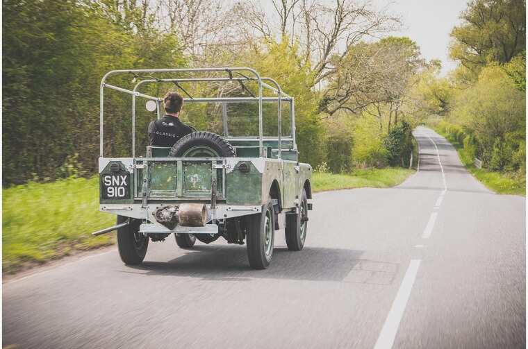 Land Rover Series I driving on road