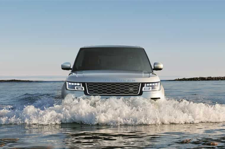 Range Rover (Grey) driving in river