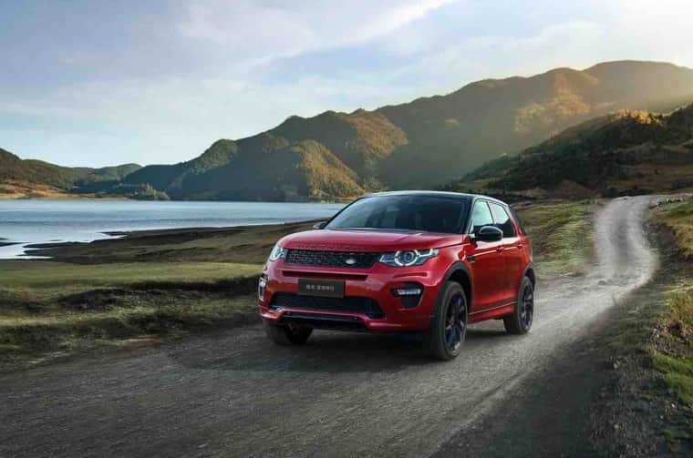 Range Rover Discovery (Red) driving on road