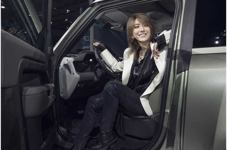 Liu Xin sitting inside Land Rover Defender