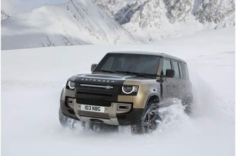 Land Rover Defender driving through snow