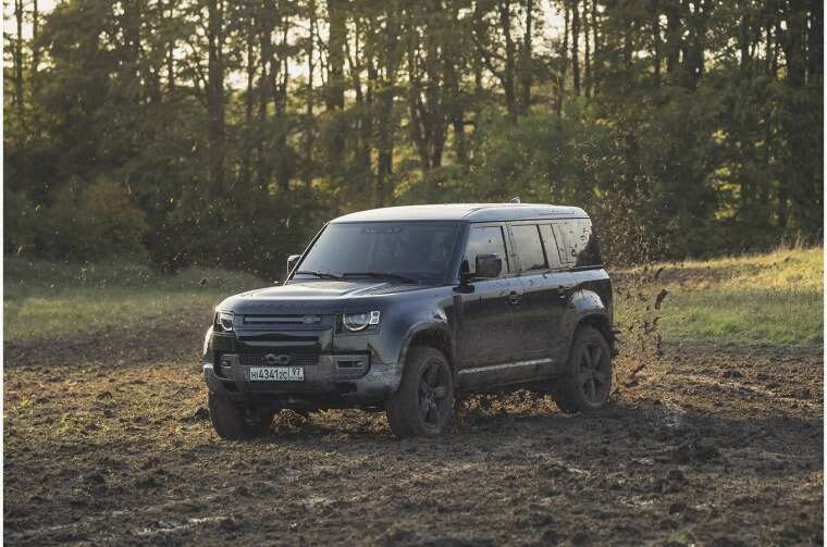 Land Rover Defender driving through mud