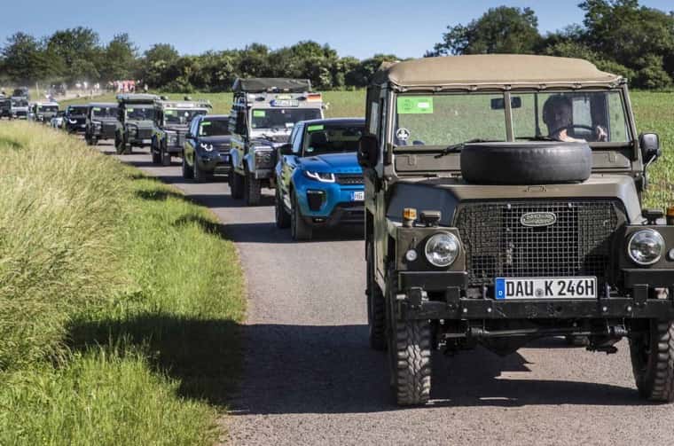 Frontal view of Land Rover parade driving on road