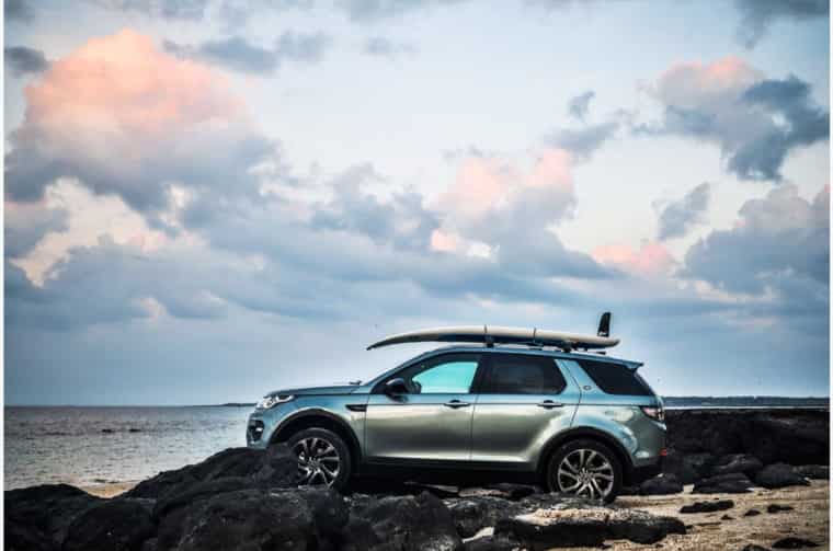 Land Rover Discovery parked on rocky beach
