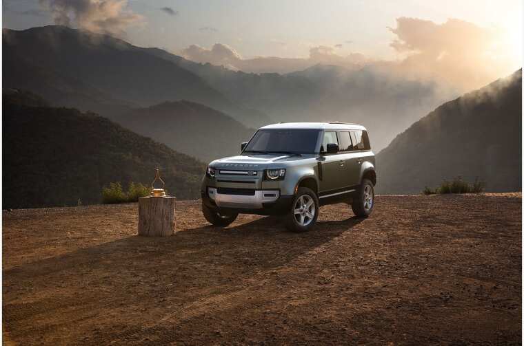 Land Rover Defender parked in mountain landscape