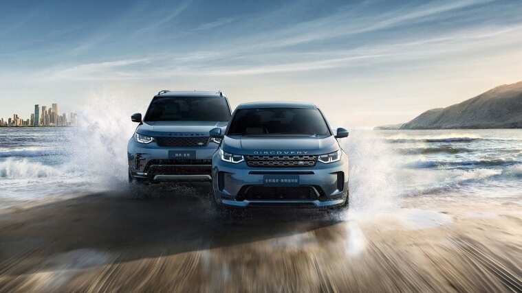 Land Rover Vehicles driving side by side in water