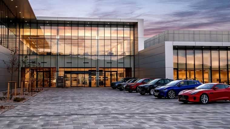A range of Jaguar Land Rover vehicles parked outside a building