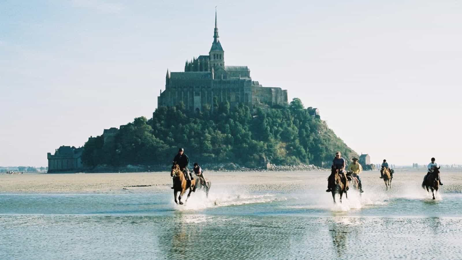 Equestrians with Mont Saint-Michel in background